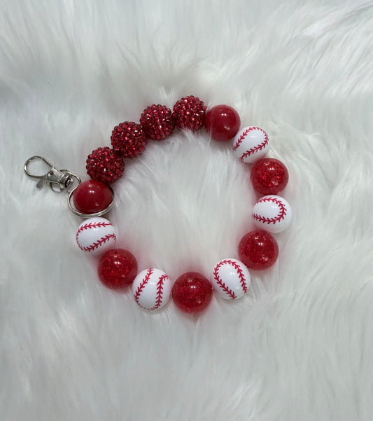 A red and white beaded bracelet featuring baseball-themed beads, glittery red pom-pom beads, and a silver lobster clasp